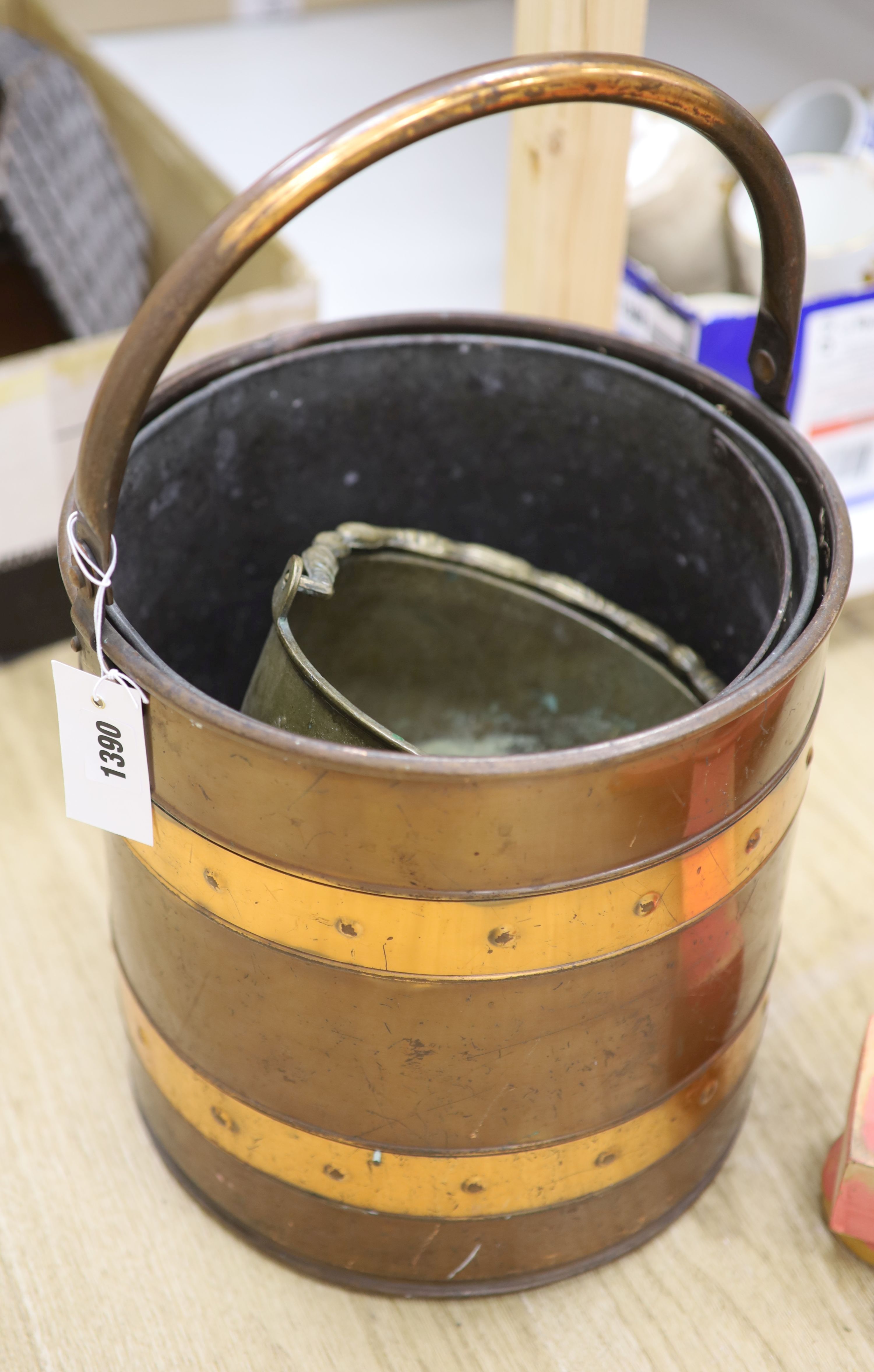 A copper and brass bucket and a lions mask door knocker and a spelter door knocker